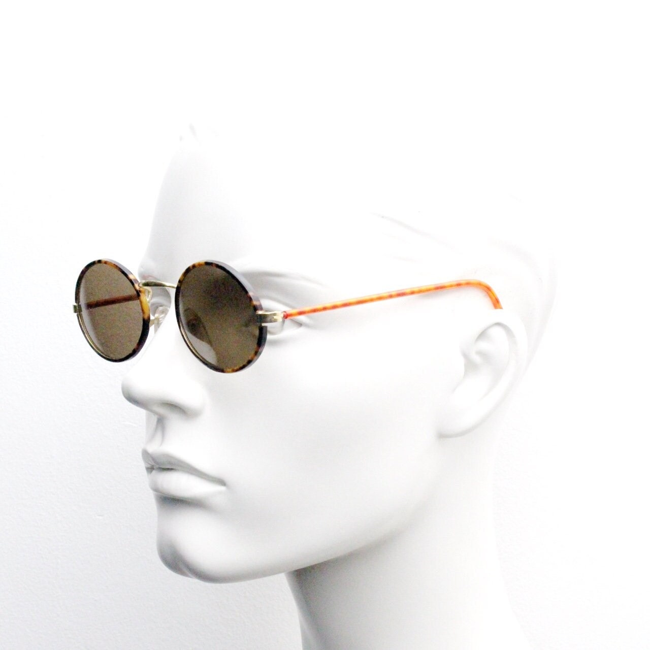 90s vintage oval sunglasses. Handsome honey tortoise and blazing amber arm combo on a slender metal frame. NOS