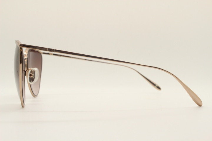 Carolina Herrera minimal cat eye sunglasses model SHN069 made in Italy. Women's  gold titanium cateye frame with brown lenses. Vintage NOS