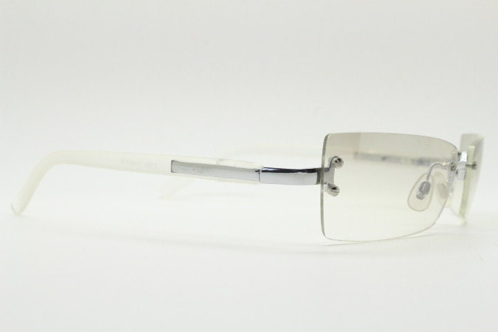 Y2K vintage  frameless sunglasses. Minimal light tone curved mirrored lenses with white frosted arms. 2000's. 90s. 00s. NOS