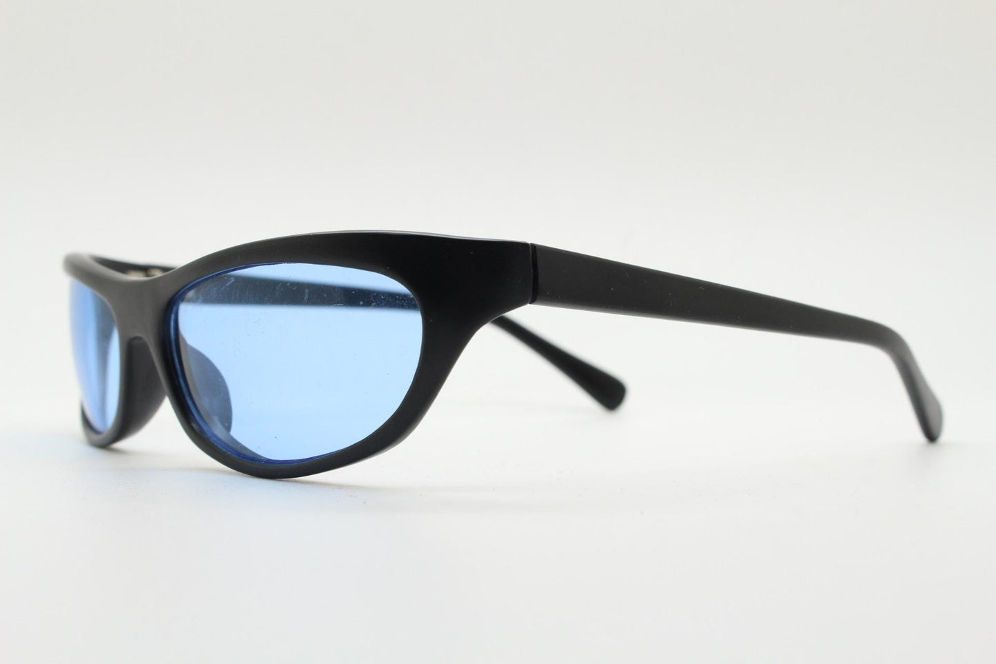 90s vintage curved wraparound sunglasses. Aerodynamic low profile black satin finish frame with light tone blue lenses. Sports shield. NOS