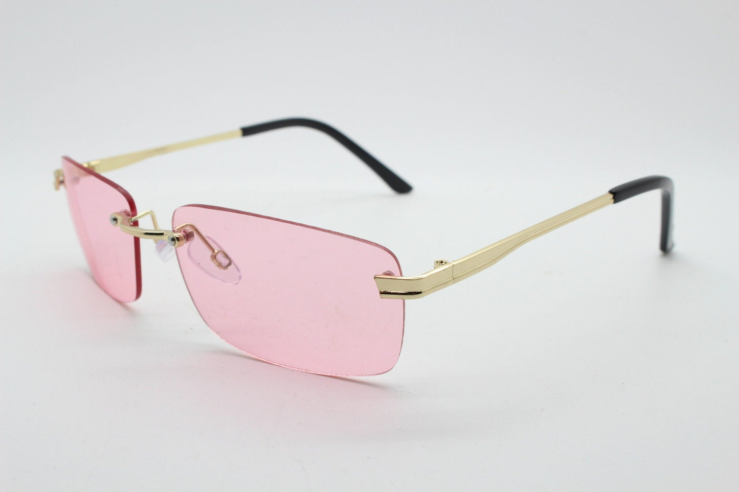 Y2K vintage frameless pink sunglasses. Rectangular lenses with gold bridge and arms. 2000s club kids. 00's. 90s Rave