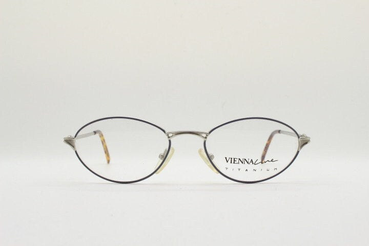 Viennaline 90s vintage oval eye glasses made in italy from titanium. Satin silver optical frame with grey enamel outline. Prescription RX