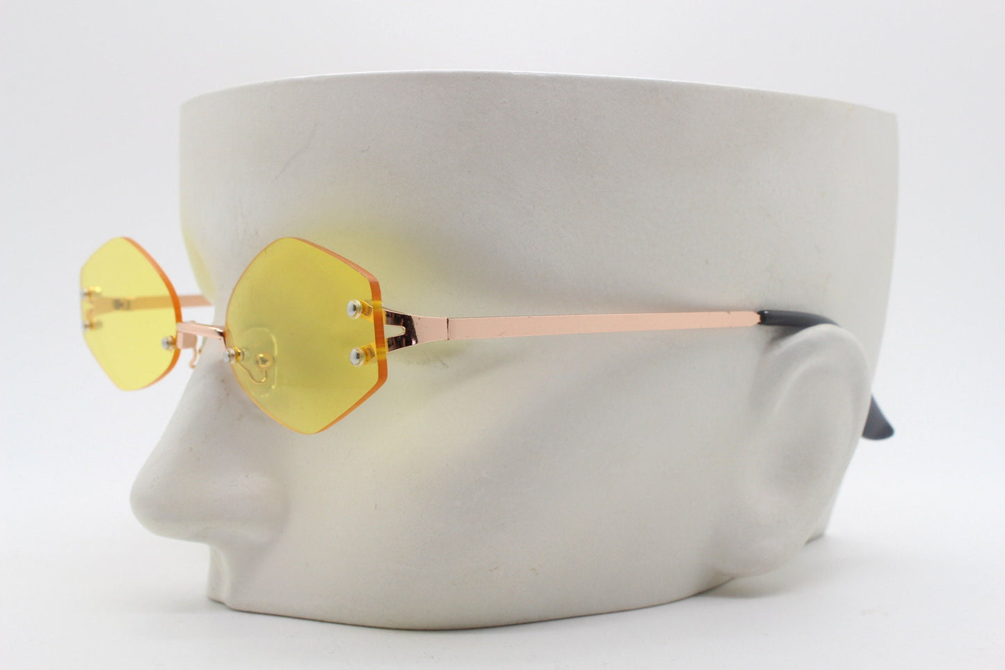 Y2K vintage frameless hexagon sunglasses. Bright yellow lenses with rose gold bridge and arms. 2000s, 00's. 90s