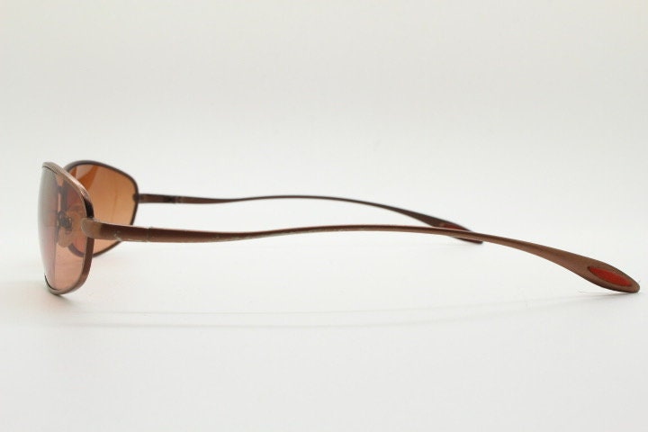 Y2K vintage oval small bug eye sunglasses. Curved copper satin finish metal frame with slender arms. Unused 2000s NOS
