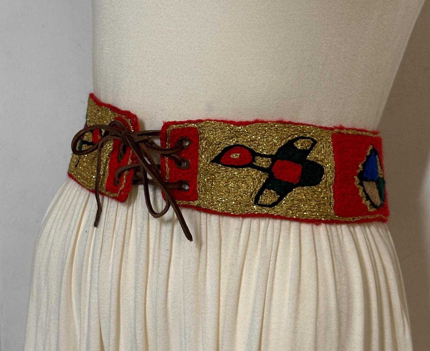 60s vintage completely hand made knitted belt. Embroidered sun, bird and abstract symbols with leather laced tie. Womens unique one off