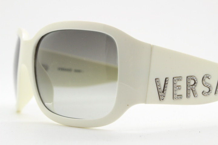 Versace Y2k vintage wrap around bug eye sunglasses. Curving white acetate shield frame with huge spell out diamante logo. 2000s. Rhinestone