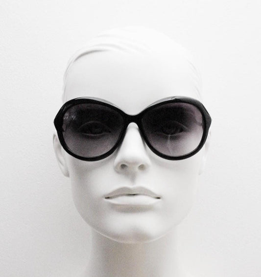 Y2K vintage big round sunglasses. Women's classical 60s design in black gloss with graduating lenses and subtle arm detail. 2000s. 00s NOS