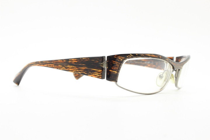 Alain Mikli 90s vintage eye glasses hand made in France. Low profile wrap around half frame in 'wood grain' acetate. Optical prescription RX