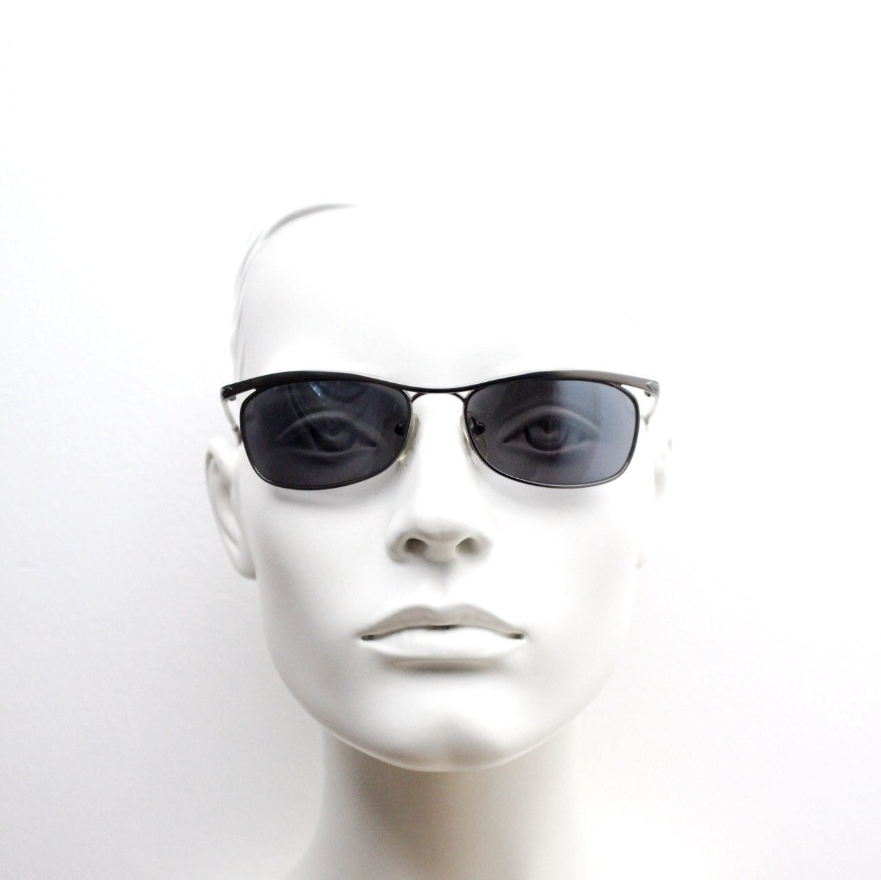 Y2K vintage curved oval sunglasses. Minimal grey chrome metal aerodynamic sport shaped frame. 2000's. 00's NOS