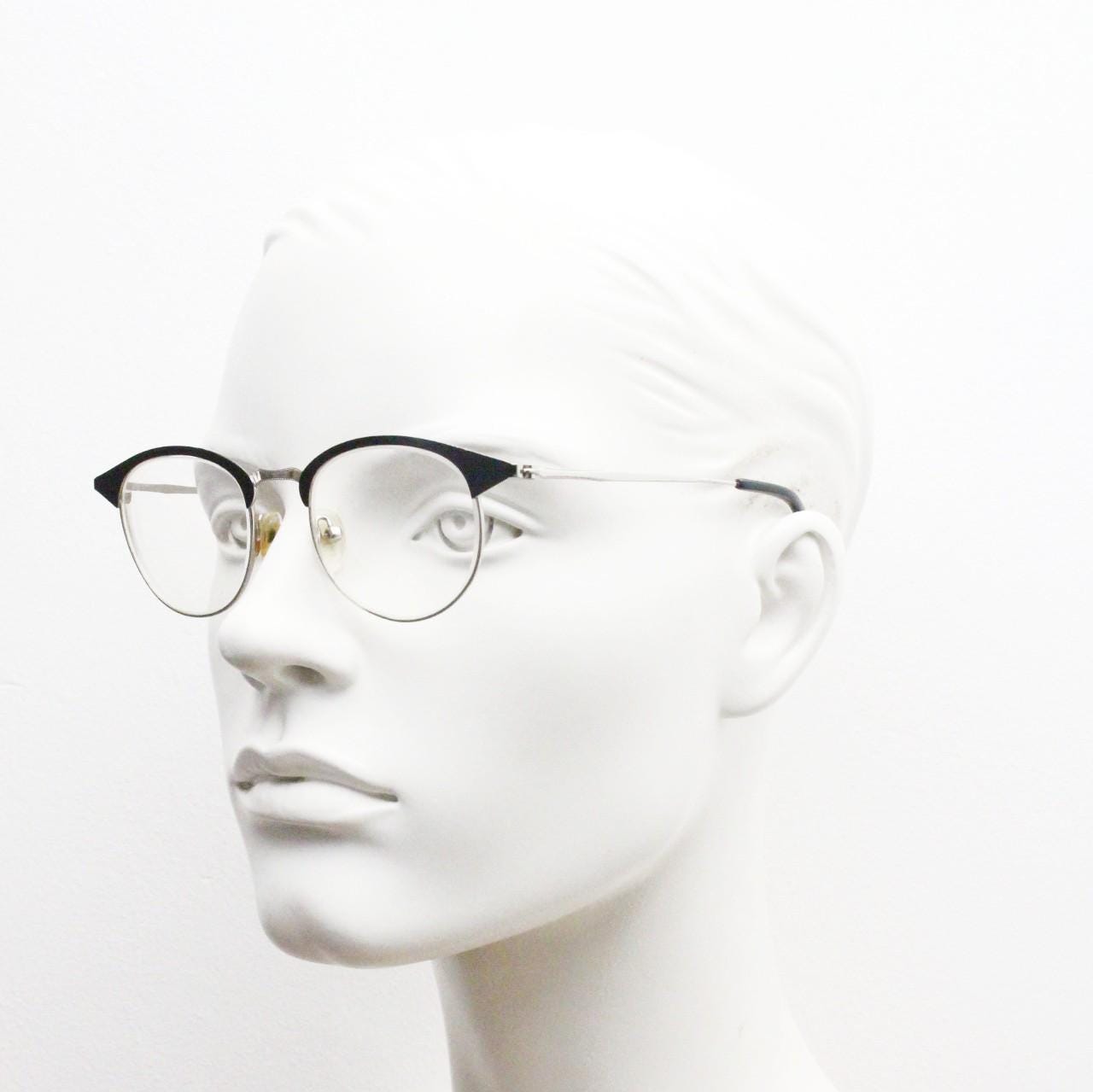 Lupo and Co round eye glasses with pointed corners. Flat metal silver optical frames with black browline. Prescription eyeglasses. RX