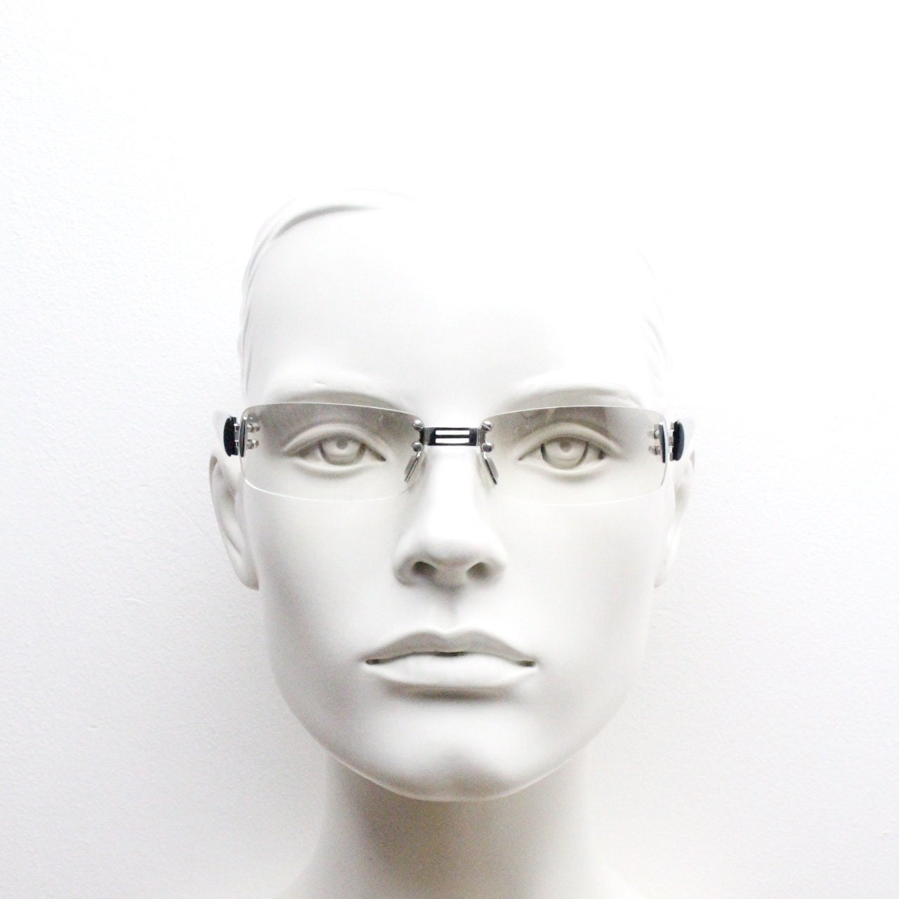 Y2K vintage frameless sunglasses. Silver chrome trim with patterned arms and extra light tone graduated curved mirror lenses. 2000's. 90s