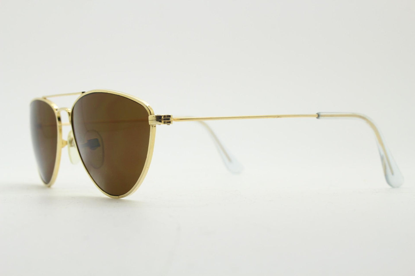 90s vintage minimal triangular sunglasses. Slim gold frame with plain brown lenses. Small modified aviator design. NOS
