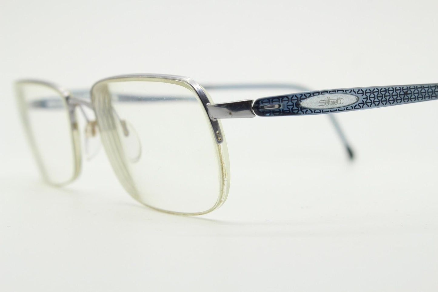 Silhouette rectangular half frame eye glasses made in Austria. Minimal brow line optical frame with patterned transparent arms. Prescription