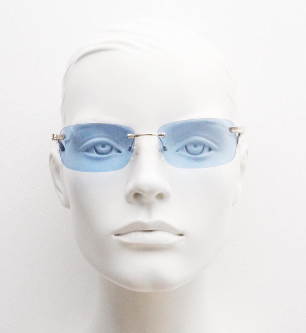 Y2K vintage frameless sky blue sunglasses. Minimalistic rectangular lenses with gold bridge and arms. 2000s club kids. 00's. 90s Rave