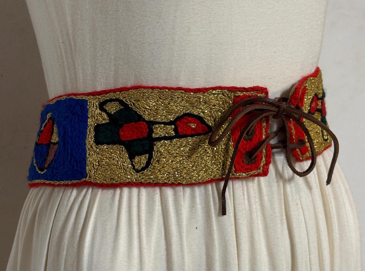 60s vintage completely hand made knitted belt. Embroidered sun, bird and abstract symbols with leather laced tie. Womens unique one off