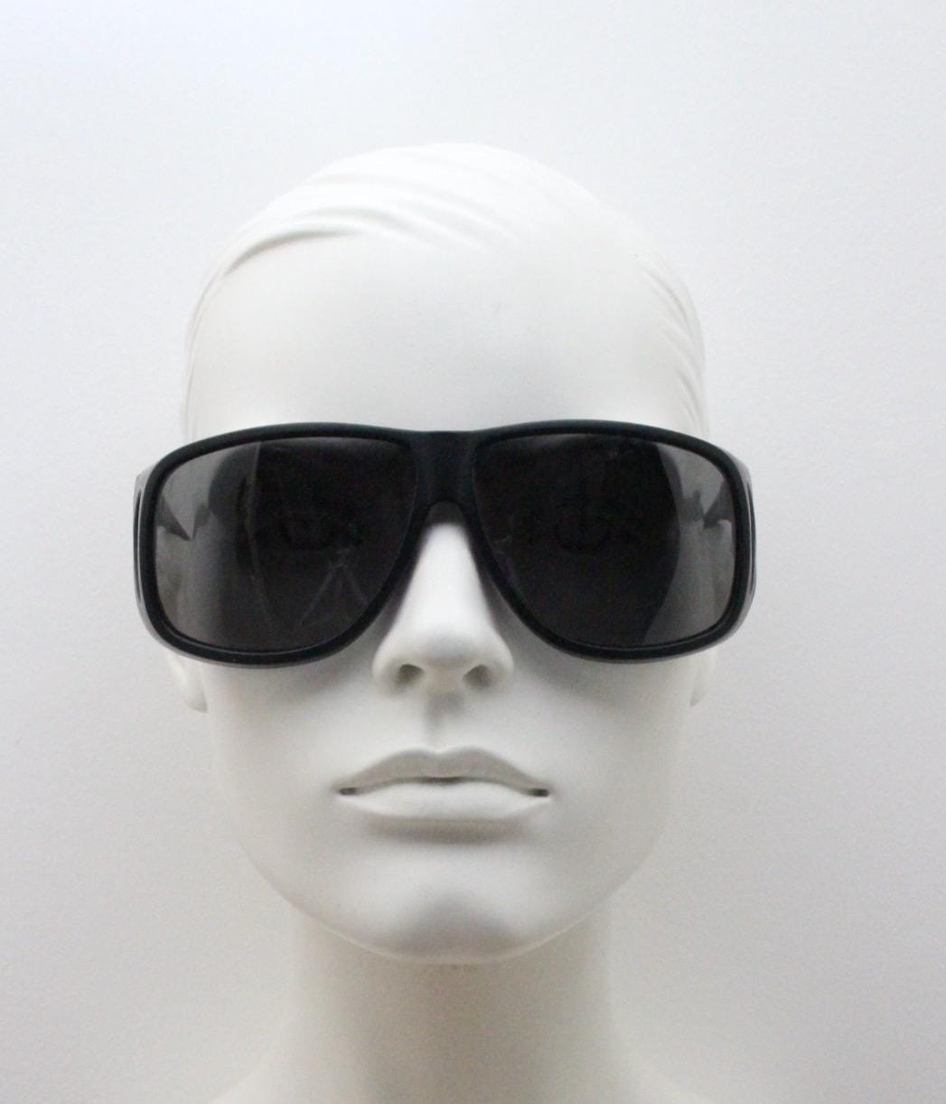 80s vintage massive oversized shield goggle sunglasses with side windows. Big black matt wrap around frame with grey lenses