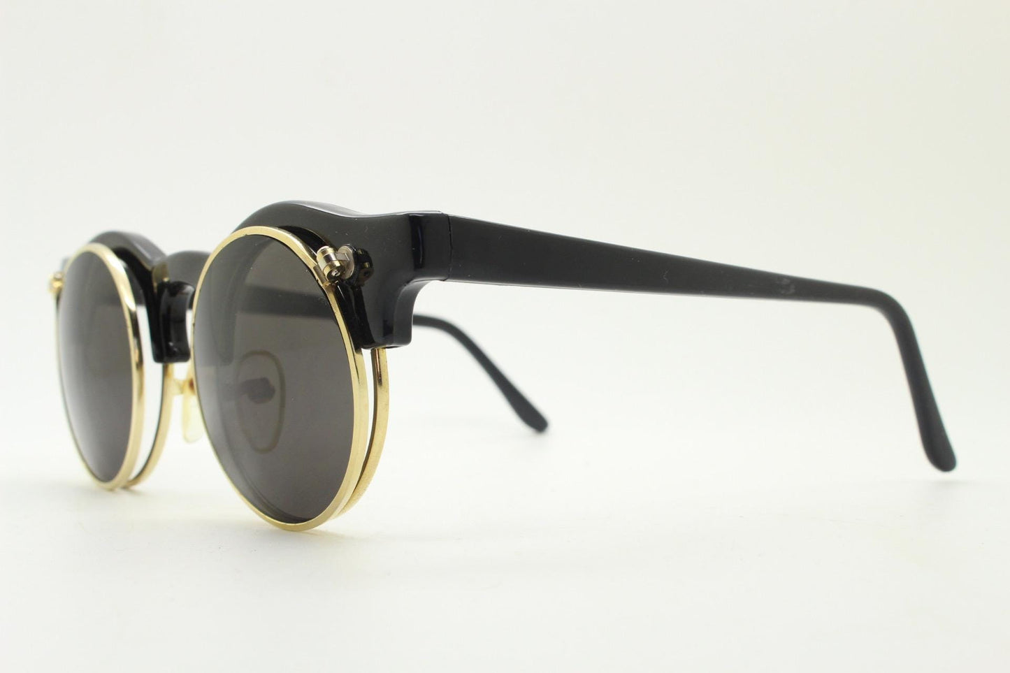 Vintage 80s round flipper sunglasses. Black gloss frame with clear lenses and incredible side flip up shades . BNWT unused NOS