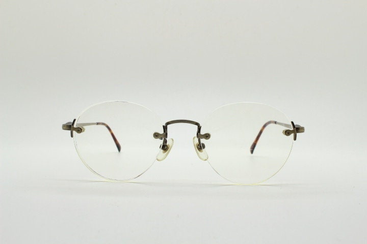 Edwin vintage 90s frameless round eye glasses model 59392A made in Japan. Minimal satin bronze finish optical frame. Prescription RX