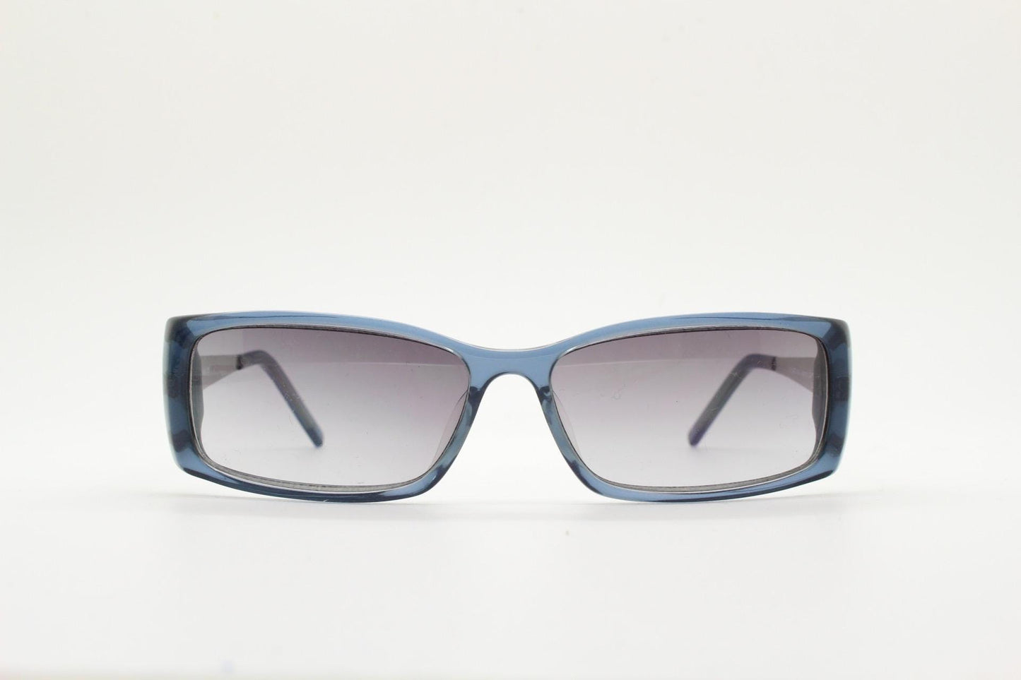 90s vintage rectangular low profile sunglasses by Storm. Transparent grey acetate front with brushed steel arms. NOS. 2000s