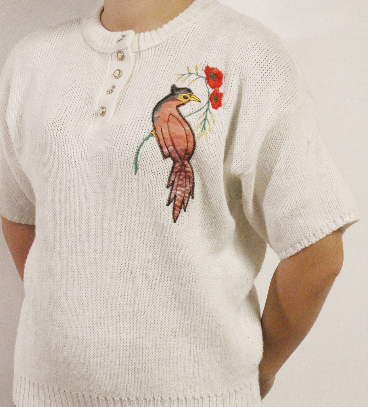 White 80s vintage knit jumper. Short sleeve womens sweater with exotic bird applique. Buttoned crew neck knitted pullover made in the UK
