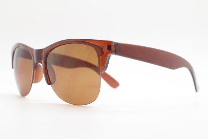 90s vintage modified wayfarer design sunglasses. Transparent brown browline half frame with brown or green interchangeable lenses . NOS