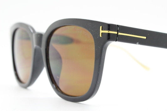 Tom Ford vintage wayfarer design sunglasses made in Italy. Slightly cat eye form in plain black gloss acetate with gold arms