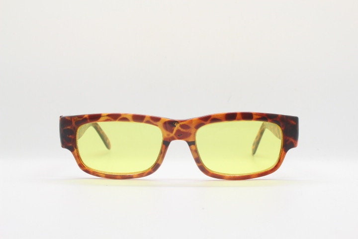 80s vintage rectangular sunglasses. Low profile 60s mod design tortoise frame with psychedelic light tone yellow lenses and fat arms. NOS
