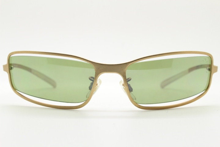 Y2K vintage wraparound sunglasses. Low profile satin finish golden slender frame with green lenses and gap feature. 2000's. 90s. NOS
