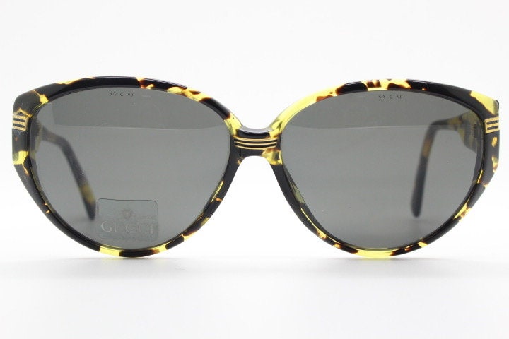 Gucci 90s vintage large oval sunglasses model 2135 made in Italy. Vibrant amber and mottled brown bug eye. NOS