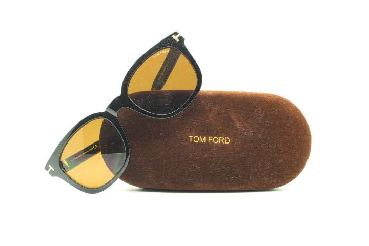 Tom Ford vintage wayfarer design sunglasses made in Italy. Slightly cat eye form in plain black gloss acetate with gold arms
