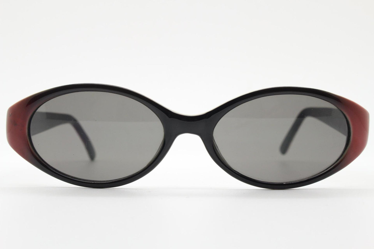 Vintage 90s oval sunglasses with very unique abstract arm pattern in black and red on layered acetate. Authentic original design. NOS