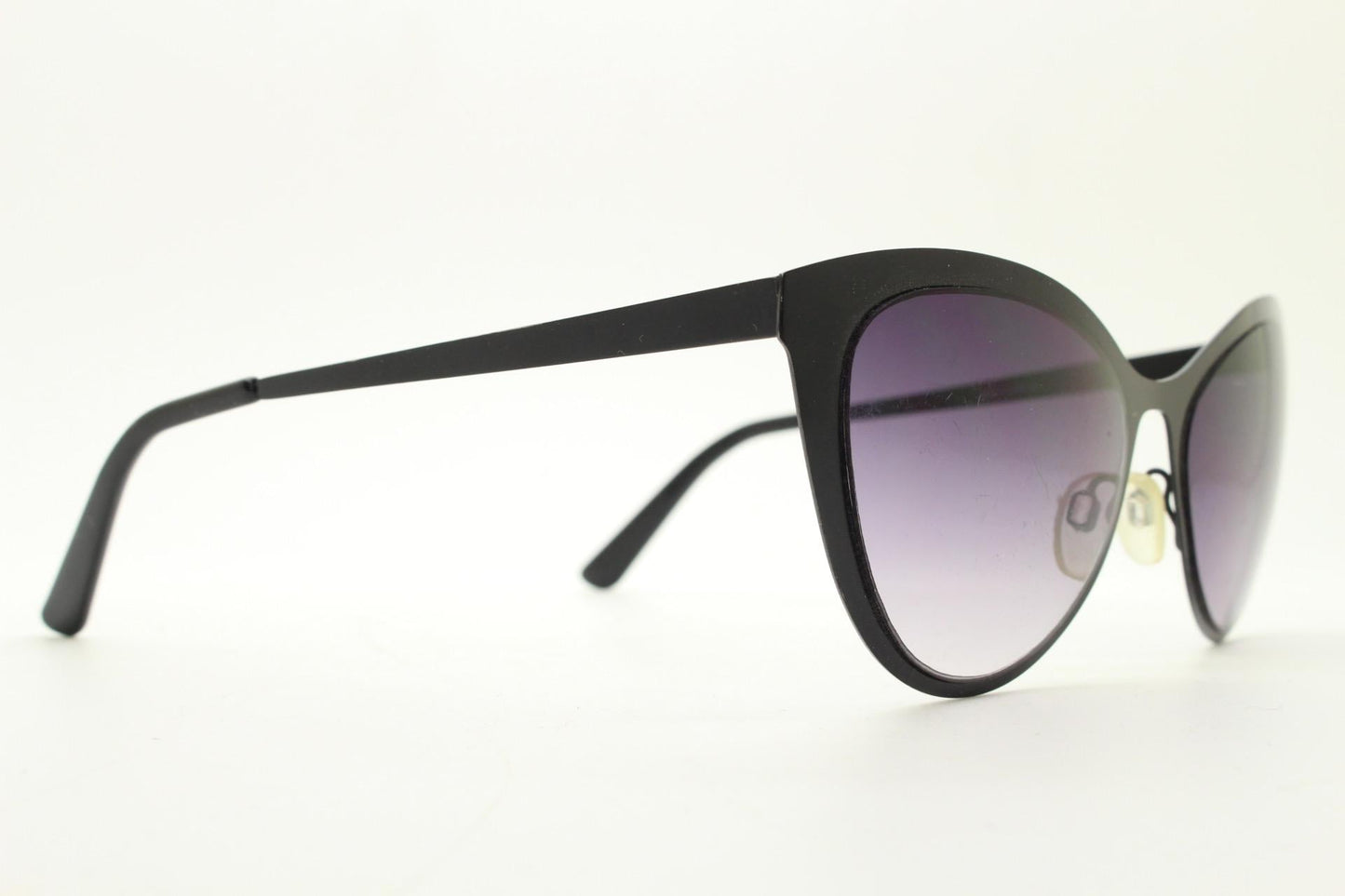 Vintage pointed cat eye sunglasses. Flat metal frame in a satin finish encasing smoky grey graduating lenses. Womens cateye