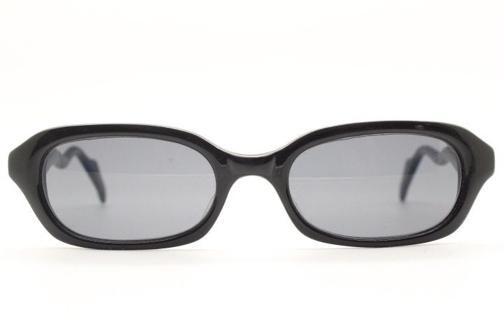 90s vintage rectangular minimal cat eye sunglasses. Small black acetate low profile frame with extraordinary waved arms. Unused NOS