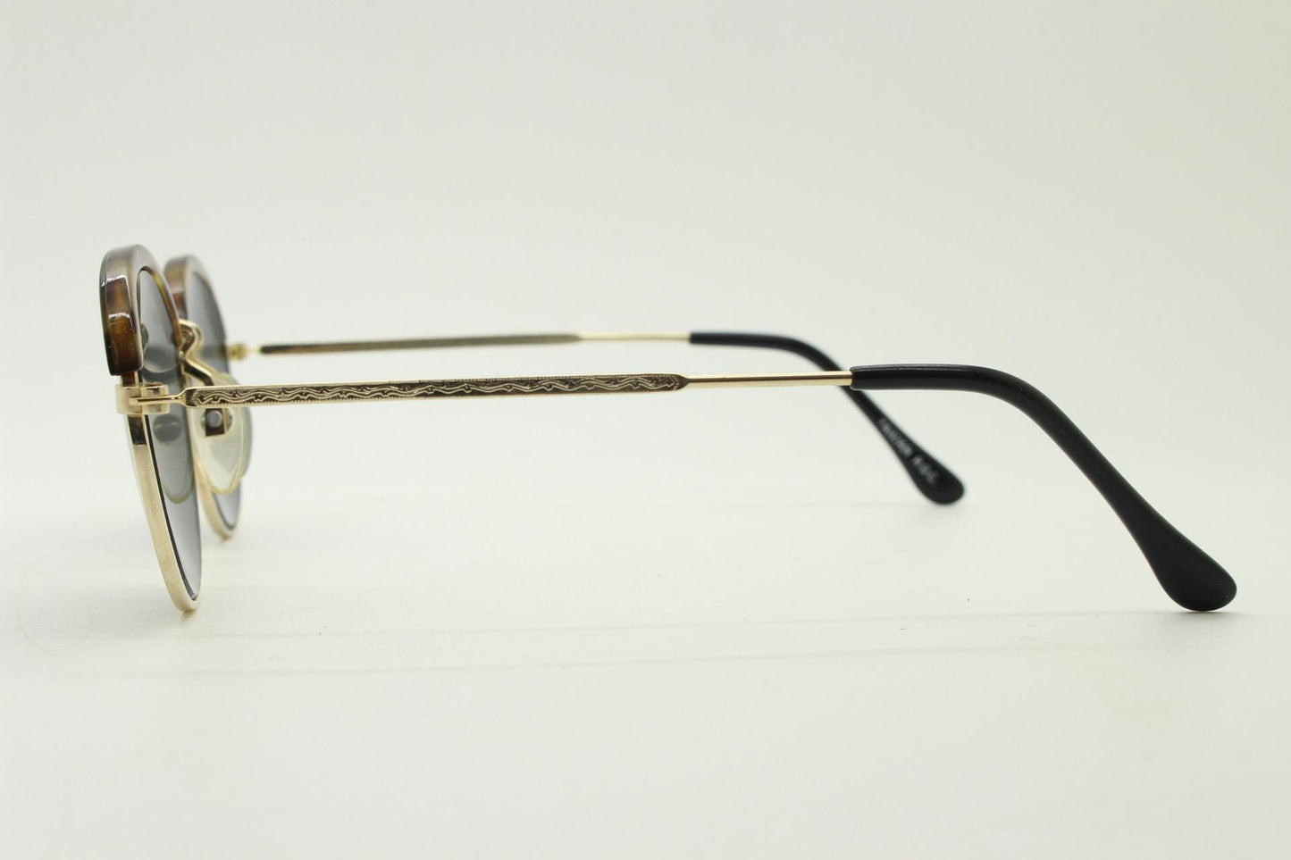 90s round vintage sunglasses. Gold frame with tortoise brows, blue mirror lenses and intricate embossed arm patterns. 1930's style