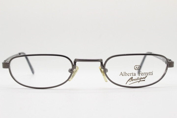 Alberta Ferretti 90s vintage oval eye glasses made in Italy. Small grey metal optical frame with ornate arm pattern. Prescription RX. NOS
