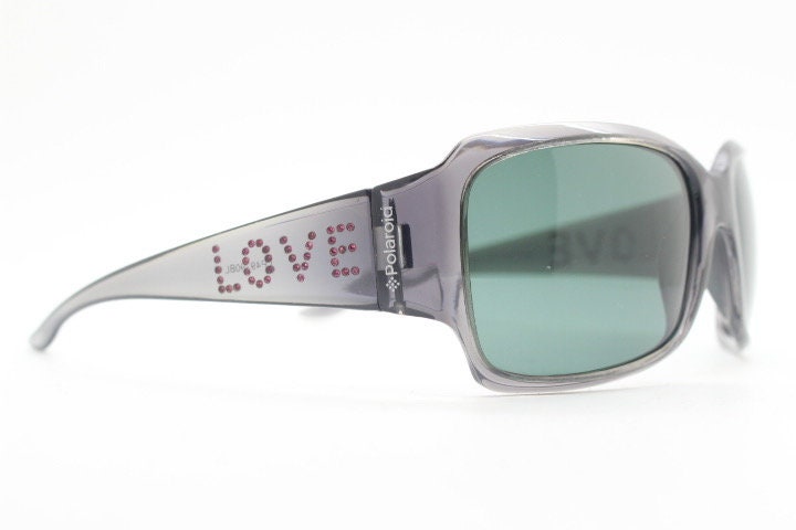 Polaroid Y2K vintage shield sunglasses. Transparent grey wrap around with red diamante LOVE logo and polarising lens. 2000s. Rhinestone