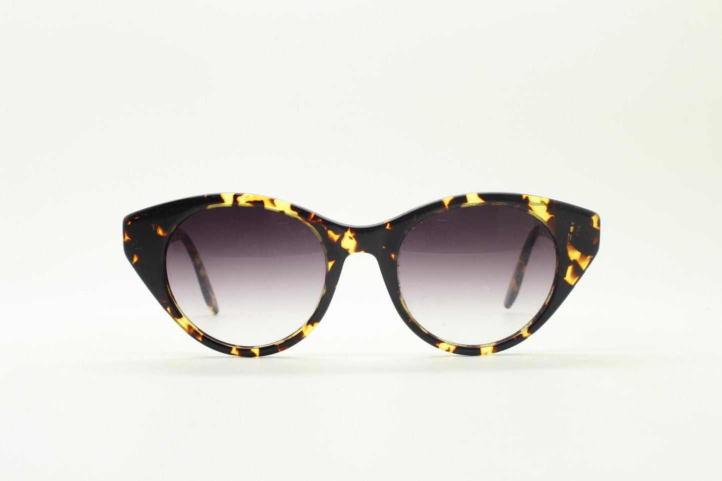 Barton Perreira subtle cat eye sunglasses model kismet. Honey tortoise acetate frame with cropped sides and graduating lenses