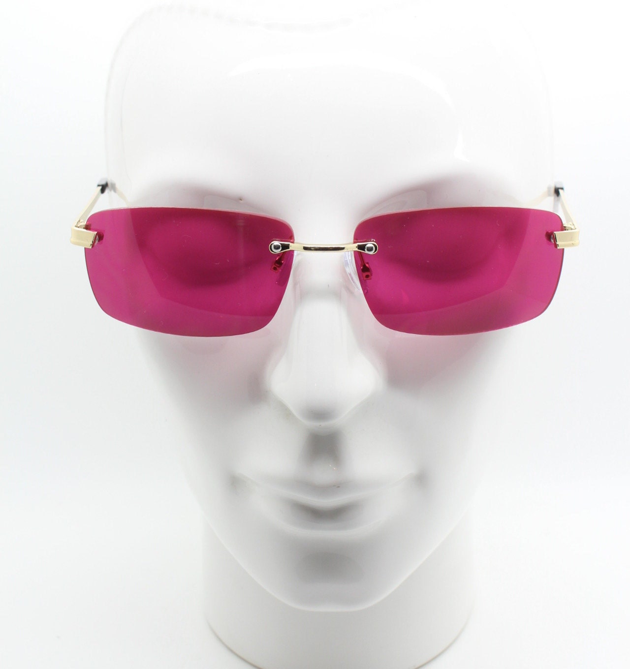 Y2K vintage frameless pink sunglasses. Rectangular lenses with gold bridge and arms. 2000s club kids. 00's. 90s Rave
