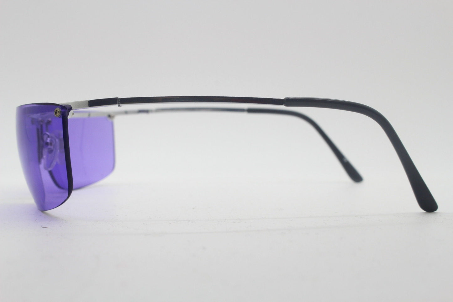 Y2K vintage purple shield sunglasses. 2000's half frame wraparound aerodynamic mini mask visor with curving lenses. 90s 00s unused NOS
