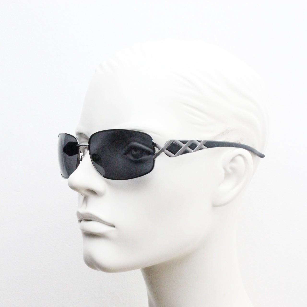 2000s vintage rectangular bug eye sunglasses. Solid metal slightly oversized grey chrome frame with diamond lattice arm detail. Y2K NOS