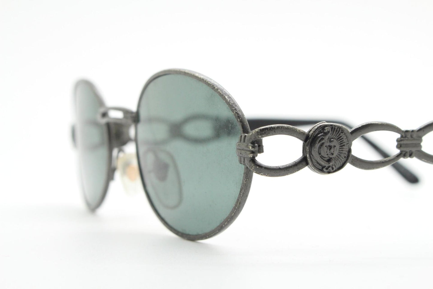 90s vintage low profile oval sunglasses. Authentic Gunmetal grey satin finish frame with chain link arm circles and real glass lenses. NOS