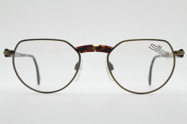 Silhouette vintage 90s flat top oval eye glasses made in Austria. Satin bronze optical frame with honey tortoise trim. Prescription RX