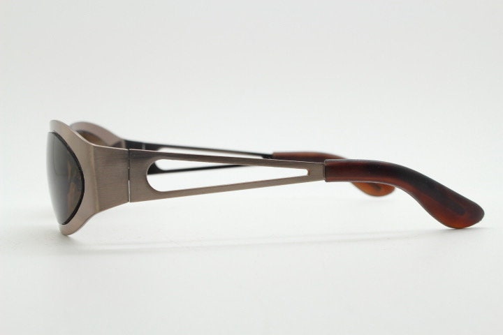 2000s vintage wraparound angular sunglasses. Brown chrome flat curved metal frame with cut out arms. 90s. Y2K unused NOS