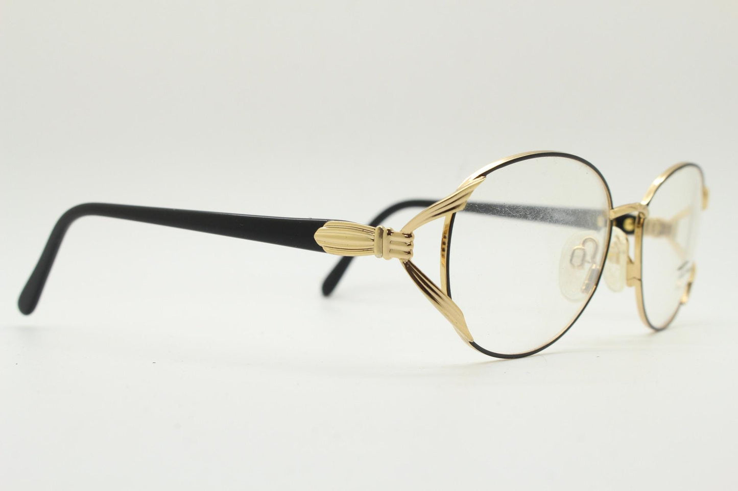 Tura 80s vintage oval eye glasses made in Italy. Womens black and gold optical frame with Y forked temples. Prescription RX. Unused NOS