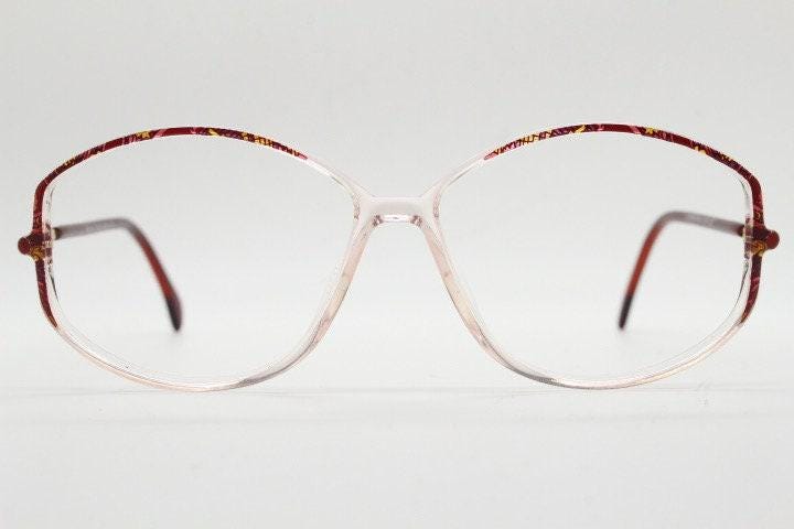 Silhouette 80s vintage hexagon eye glasses made in Austria. Transparent crystal optical frame with abstract red pattern. Prescription RX