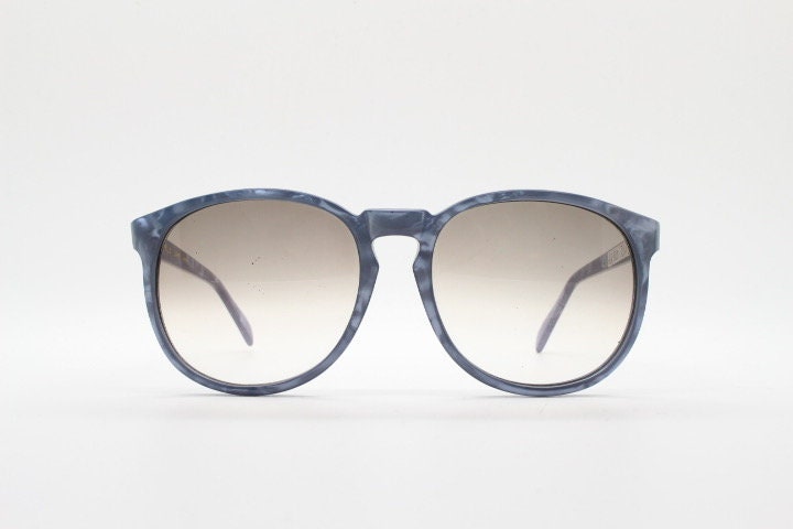 Michele L'Amy 80s vintage round sunglasses made in France. Lustrous marbled blue frame with keyhole bridge and graduating brown lenses