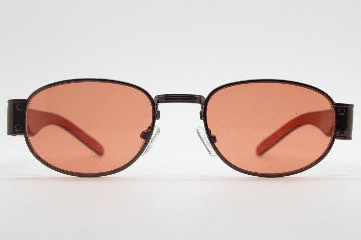 90s vintage low profile sunglasses. Brown chrome frame with thick transparent amber arms and orange lenses. Unused. BNWT