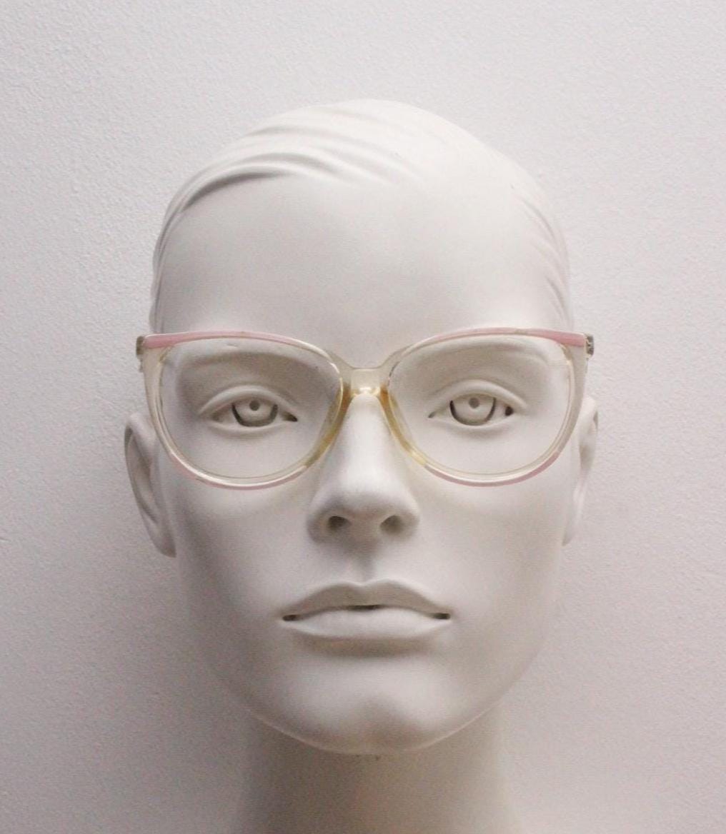 Invicta 80s vintage oversized cat eye glasses made in England. Ice white and pink acetate prescription optical frame with undulating arms