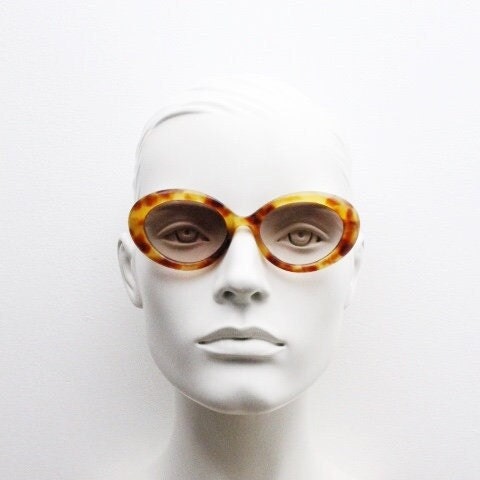 Lanvin 90s vintage chunky oval sunglasses made in France. Mottled honey brown acetate 60s design with detailed arms and light tone lenses