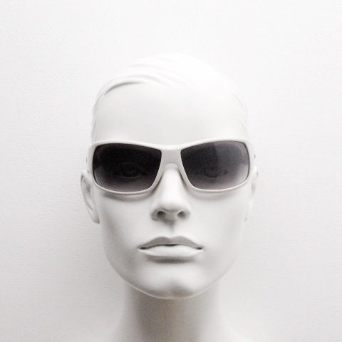 Uvex Y2k vintage wrap around bug eye sunglasses. Curving white sports shield frame with black lenses and tartan interior. Rave 2000s. NOS